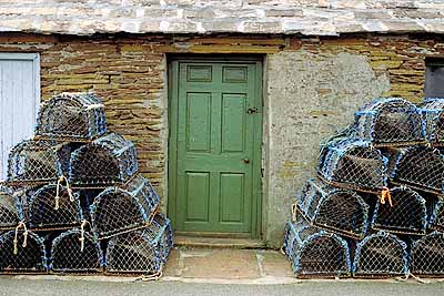 Lobster pots by cottage. Location: SCO, Orkney Islands , Mainland (Island), Stromness. [ref. to #177.037]