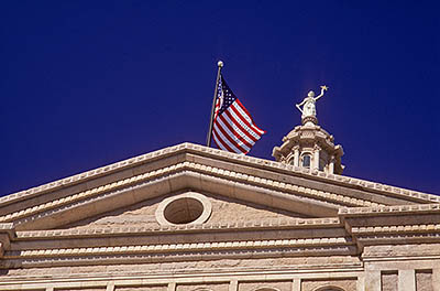 Pediment on front entrance with US flag and statue of Justice. Location: TX, Travis County, Austin, State of Texas Capitol Building. [ref. to #208.044]