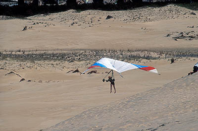 Hang gliders on large sand dunes. Location: NC, Dare County, The Outer Banks, Nags Head & Kitty Hawk, on Bodie Island, Jockeys Ridge State Park. [ref. to #224.502]