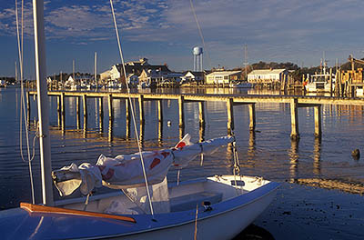 NC: Hyde County, The Outer Banks, Ocracoke Island, Ocracoke Village, View across harbor (known as Silver Lake) towards village; small sailboat in frgd [Ask for #241.328.]