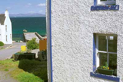 Old fishermen's cottages line the waterfront of this small village on Loch Indaal. Location: UK, Scotland, Argyll & Bute , Inner Hebrides, Islay, Port Charlotte. [ref. to #246.542]