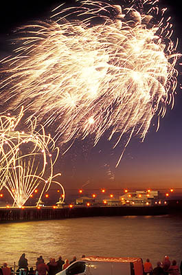 ENG: Manchester-Liverpool Urban Area, Blackpool Borough, Historic Town Center, North Pier, International Fireworks Competition at the Illuminations Festival; people crowd along the seawall as fireworks explode over the pier [Ask for #262.081.]