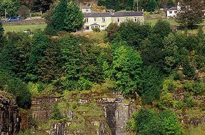 ENG: Northumbria Region, Durham, Stanhope, Miners' row houses perch on the high wall edge of an abandoned strip mine [Ask for #262.406.]