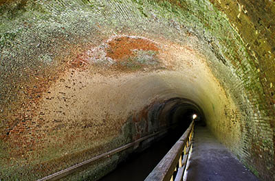 MD: Allegany County, Potomac River, The Chesapeake and Ohio Canal Nat Hist Park, Paw Paw Tunnel, Interior; the towpath, cantilevered over the water, forms a walking and bicycling path through the brick-lined tunnel [Ask for #269.078.]