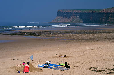 ENG: Yorkshire & Humberside Region, North Yorkshire, North Yorkshire Coast, Saltburn-by-the-Sea, Saltburn Sands. Families enjoy the beach, with the cliffs in the background [Ask for #270.484.]
